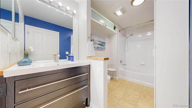 bathroom featuring tile patterned floors, vanity, toilet, and washtub / shower combination