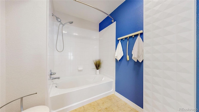 bathroom featuring tile patterned flooring, baseboards, toilet, a textured wall, and  shower combination