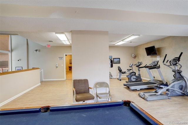 exercise room with billiards, baseboards, and wood finished floors