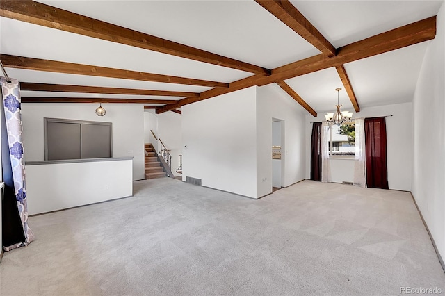 carpeted spare room featuring visible vents, a notable chandelier, vaulted ceiling with beams, and stairway