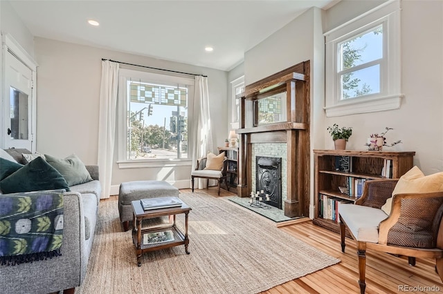 493 S Lincoln St, Denver, CO 80209 - sitting room with wood finished floors, recessed lighting, a fireplace with raised hearth, and a healthy amount of sunlight