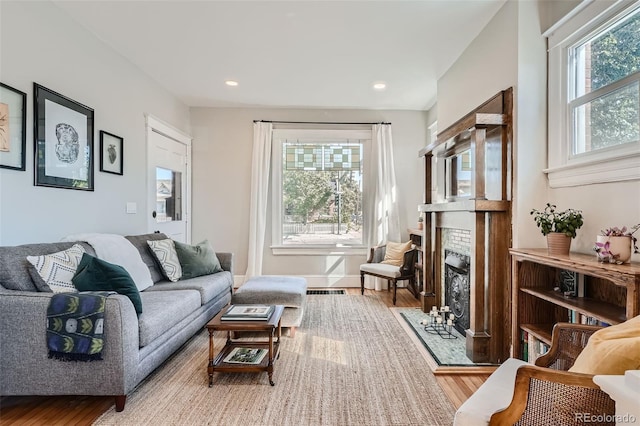 493 S Lincoln St, Denver, CO 80209 - living area with a fireplace with flush hearth, wood finished floors, and recessed lighting