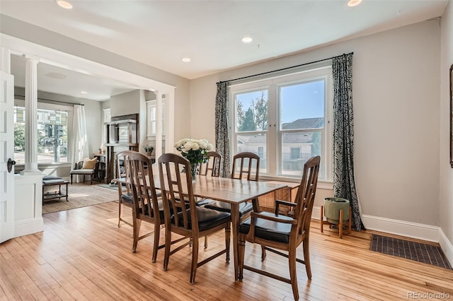 493 S Lincoln St, Denver, CO 80209 - dining room featuring baseboards, recessed lighting, light wood-type flooring, and decorative columns