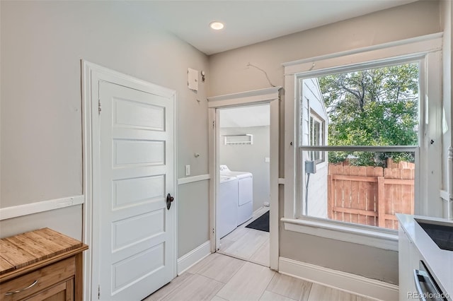 493 S Lincoln St, Denver, CO 80209 - doorway with washing machine and clothes dryer and baseboards