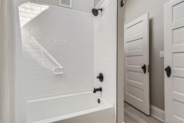 493 S Lincoln St, Denver, CO 80209 - full bath featuring wood finished floors, visible vents, baseboards, and shower / tub combo