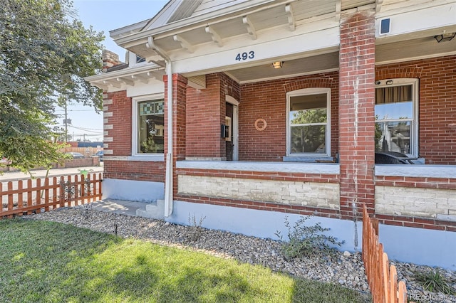 493 S Lincoln St, Denver, CO 80209 - entrance to property with brick siding, a porch, and fence