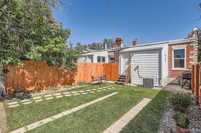 493 S Lincoln St, Denver, CO 80209 - rear view of house with a yard, entry steps, a chimney, and fence