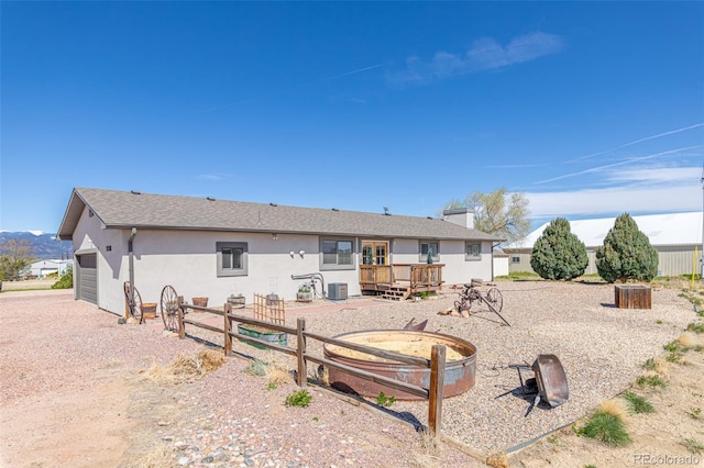 11170 Peaceful Valley Rd, Colorado Springs, CO 80925 - rear view of house featuring a deck, stucco siding, and a garage