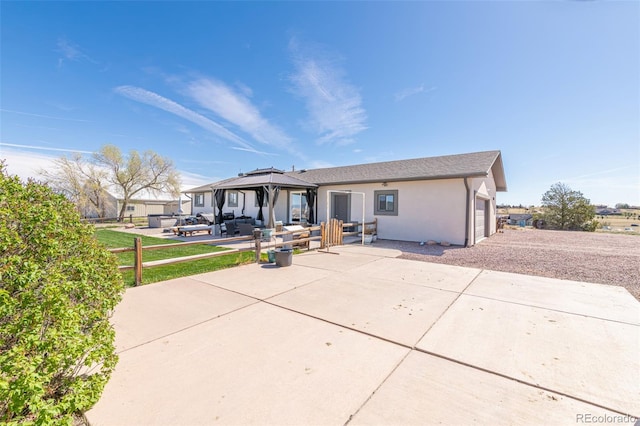 11170 Peaceful Valley Rd, Colorado Springs, CO 80925 - rear view of property featuring a gazebo, stucco siding, a garage, and a patio