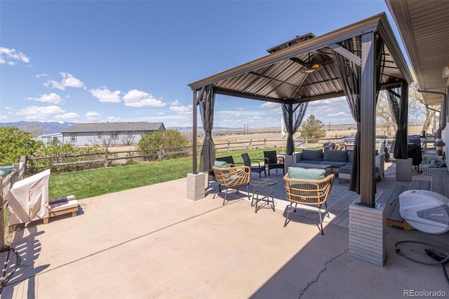 11170 Peaceful Valley Rd, Colorado Springs, CO 80925 - fenced backyard featuring outdoor lounge area, a gazebo, a patio area, and a mountain view