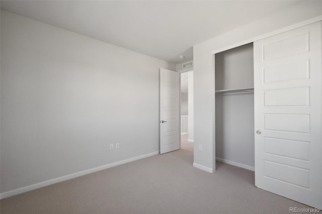 unfurnished bedroom with a closet, baseboards, and carpet