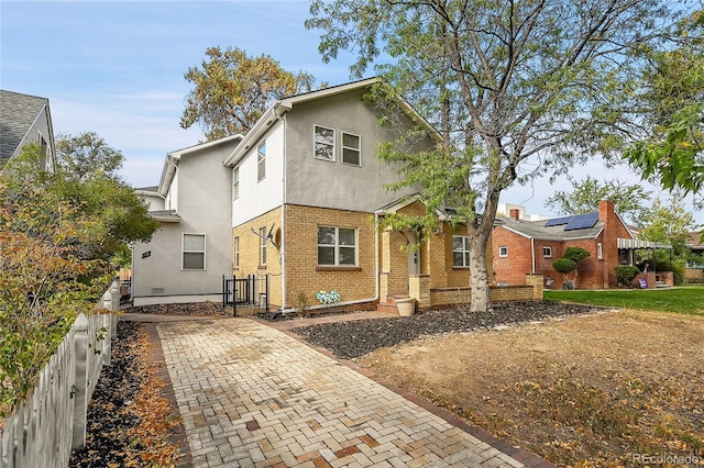 1431 Tamarac St, Denver, CO 80220 - view of front of property with stucco siding, brick siding, fence, and a gate