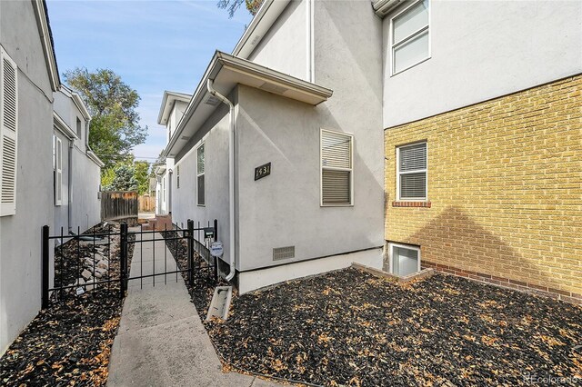 1431 Tamarac St, Denver, CO 80220 - view of side of property with stucco siding and fence