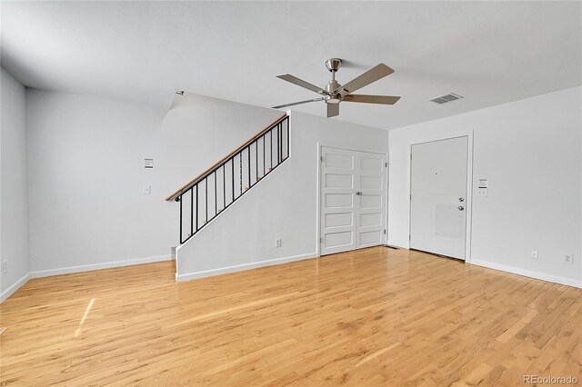 1431 Tamarac St, Denver, CO 80220 - unfurnished living room with a ceiling fan, baseboards, visible vents, stairs, and light wood-style floors