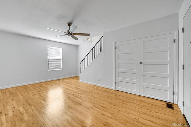 unfurnished living room featuring light hardwood / wood-style floors and ceiling fan