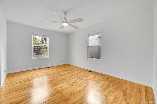 empty room with light wood-type flooring and ceiling fan