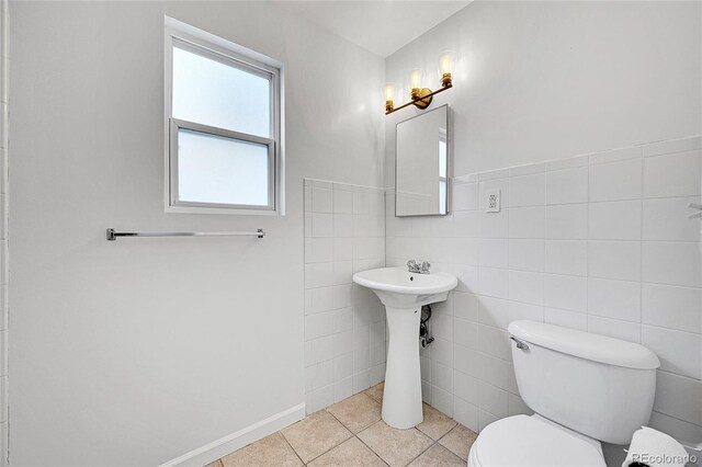 1431 Tamarac St, Denver, CO 80220 - bathroom with tile patterned flooring, toilet, and tile walls