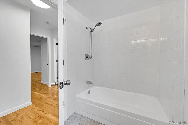 1431 Tamarac St, Denver, CO 80220 - bathroom with bathtub / shower combination, wood finished floors, and baseboards