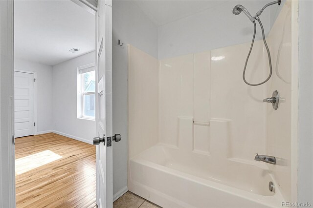 1431 Tamarac St, Denver, CO 80220 - full bath featuring shower / bath combination, baseboards, visible vents, and wood finished floors
