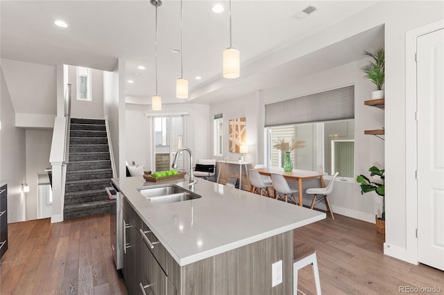 kitchen with light countertops, dark wood finished floors, visible vents, and a sink