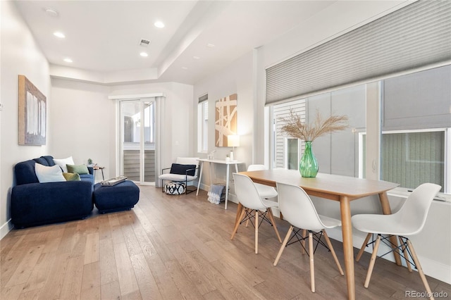 dining room with visible vents, baseboards, hardwood / wood-style floors, and recessed lighting