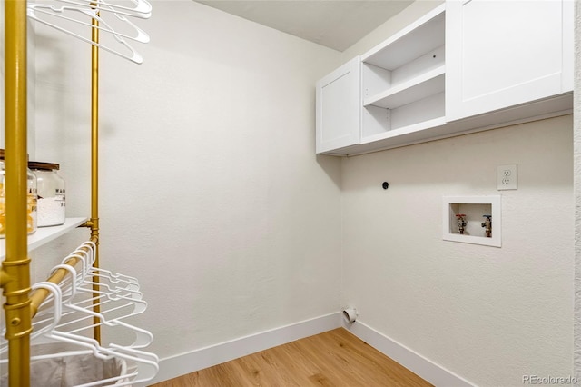 201 Wright St Unit 106, Lakewood, CO 80228 - clothes washing area with baseboards, hookup for a washing machine, light wood-style floors, and cabinet space