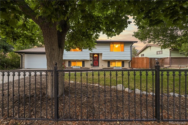 13055 E Dakota Ave, Aurora, CO 80012 - split foyer home featuring brick siding and a fenced front yard