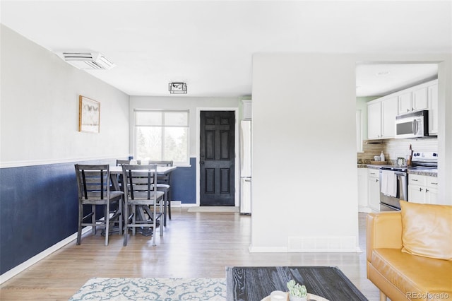 13055 E Dakota Ave, Aurora, CO 80012 - dining area featuring baseboards and light wood finished floors