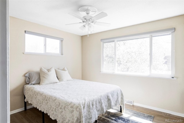 13055 E Dakota Ave, Aurora, CO 80012 - bedroom with wood finished floors, multiple windows, and ceiling fan