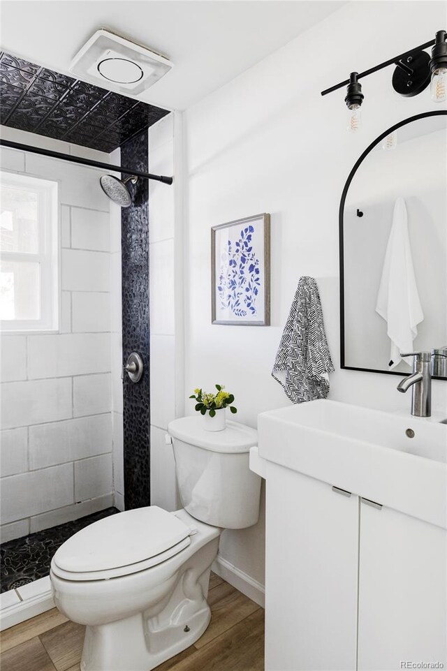 13055 E Dakota Ave, Aurora, CO 80012 - full bath featuring vanity, a stall shower, and wood finished floors