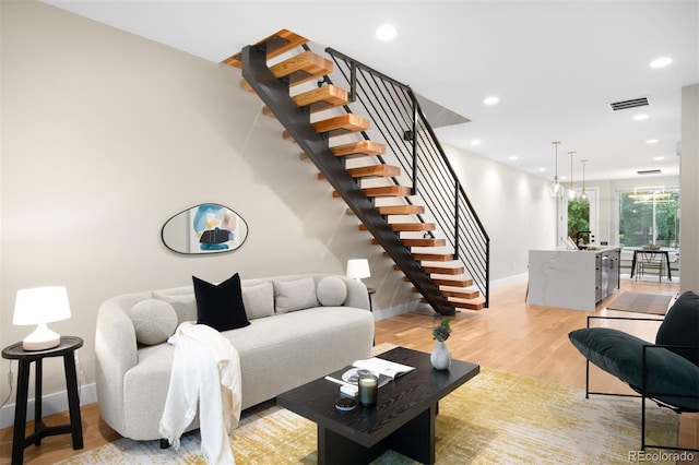 2179 S Bannock St, Denver, CO 80223 - living area featuring stairs, baseboards, light wood-type flooring, and recessed lighting