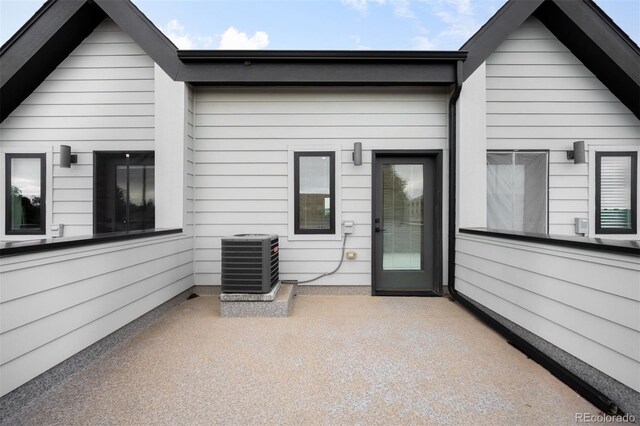 2179 S Bannock St, Denver, CO 80223 - rear view of house featuring central AC and a patio area
