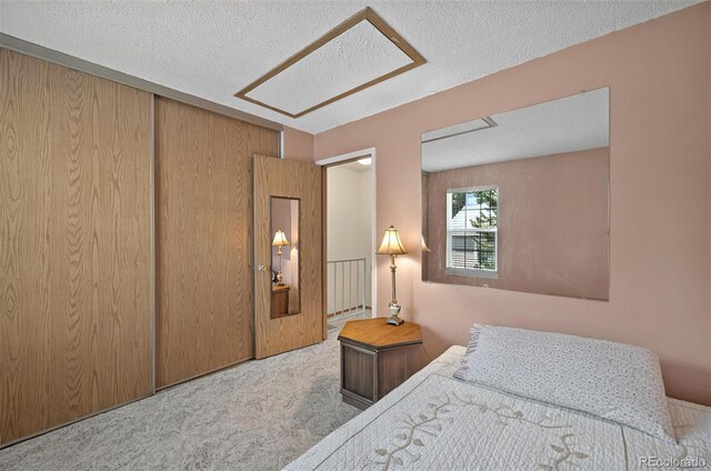 carpeted bedroom featuring a textured ceiling