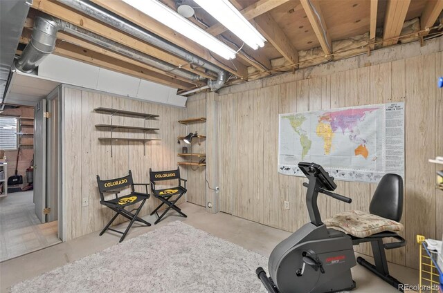 workout area featuring wood walls