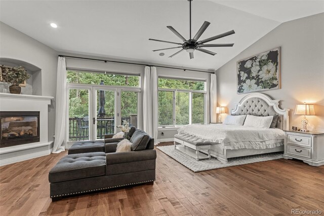 bedroom featuring hardwood / wood-style flooring, access to outside, lofted ceiling, and ceiling fan