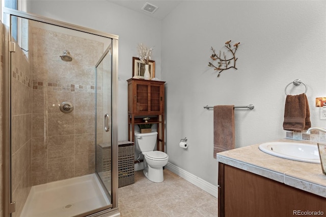 bathroom with vanity, tile patterned floors, toilet, and an enclosed shower