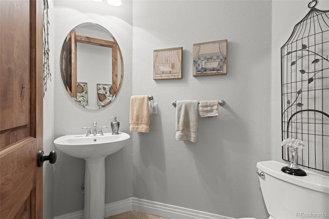 bathroom featuring toilet and sink