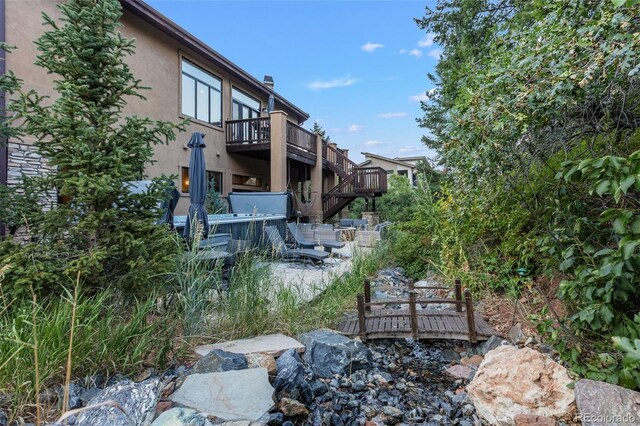 view of yard featuring a patio area and a deck