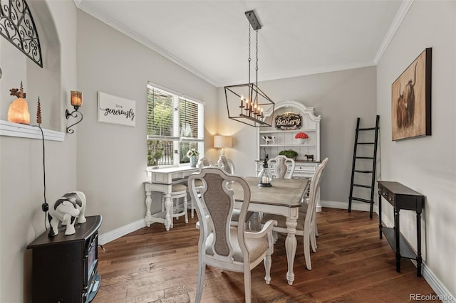 dining area featuring dark hardwood / wood-style floors, a chandelier, and ornamental molding