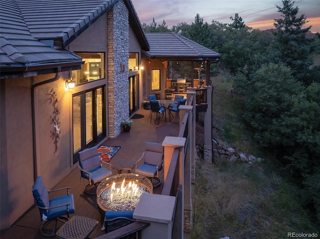 back house at dusk with an outdoor fire pit