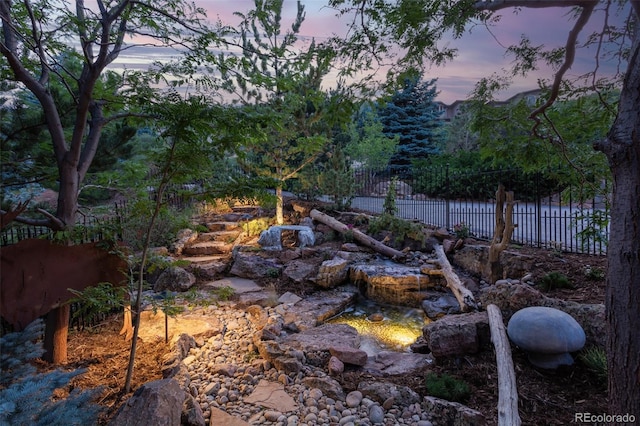 view of yard at dusk