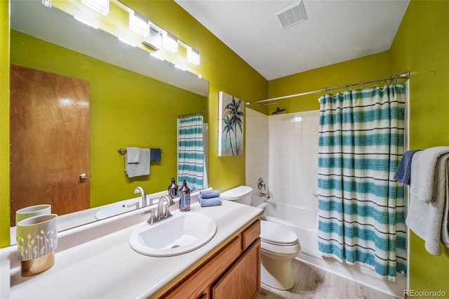 full bath with shower / tub combo, toilet, visible vents, vanity, and wood finished floors