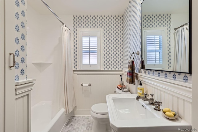1224 Glencoe St, Denver, CO 80220 - bathroom featuring wallpapered walls, a wainscoted wall, shower / bath combo with shower curtain, and tile patterned flooring