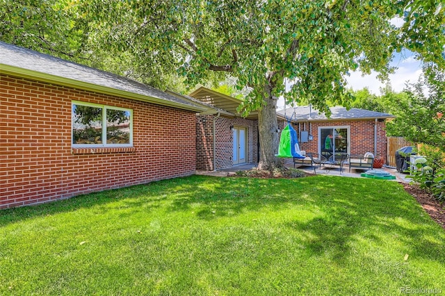 1224 Glencoe St, Denver, CO 80220 - back of property with brick siding and a patio