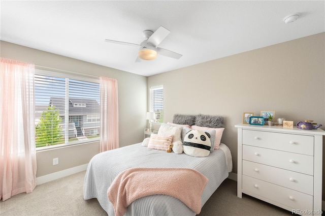 12845 Park Creek Way, Firestone, CO 80504 - bedroom with baseboards, multiple windows, light carpet, and ceiling fan