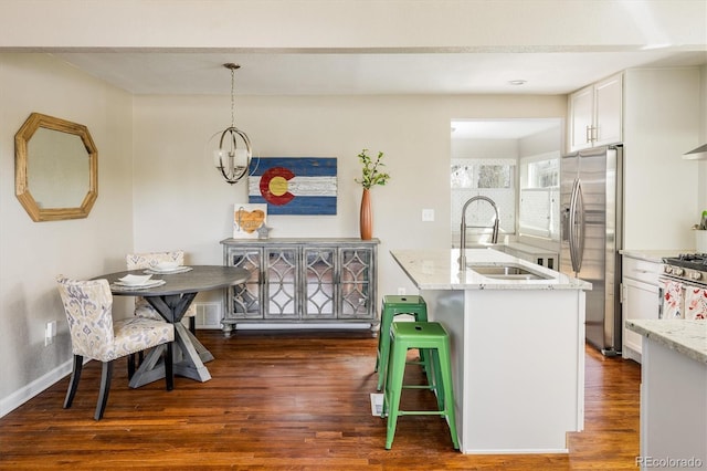 190 S Canosa Ct, Denver, CO 80219 - kitchen with stainless steel appliances, white cabinets, a sink, and light stone counters