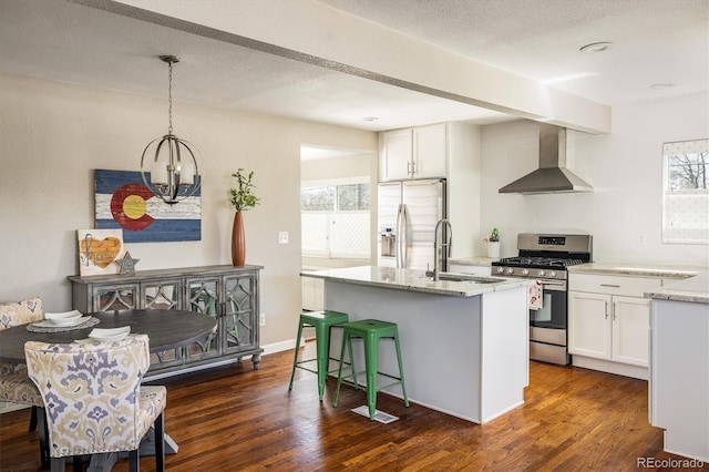 190 S Canosa Ct, Denver, CO 80219 - kitchen featuring a sink, wall chimney range hood, a healthy amount of sunlight, light stone countertops, and stainless steel appliances