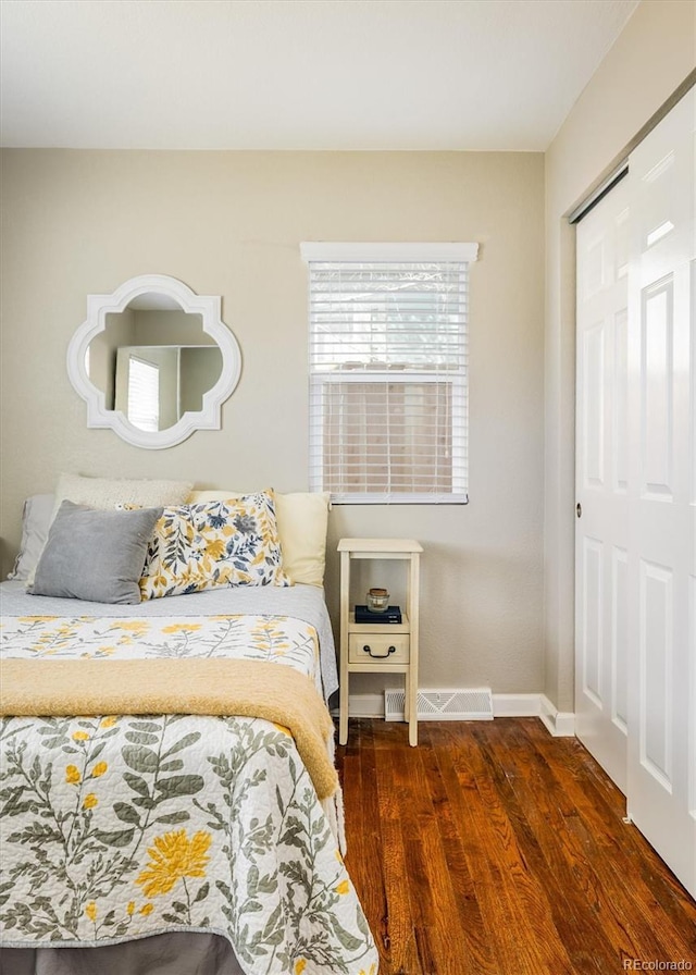 190 S Canosa Ct, Denver, CO 80219 - bedroom featuring wood finished floors, baseboards, a closet, and visible vents