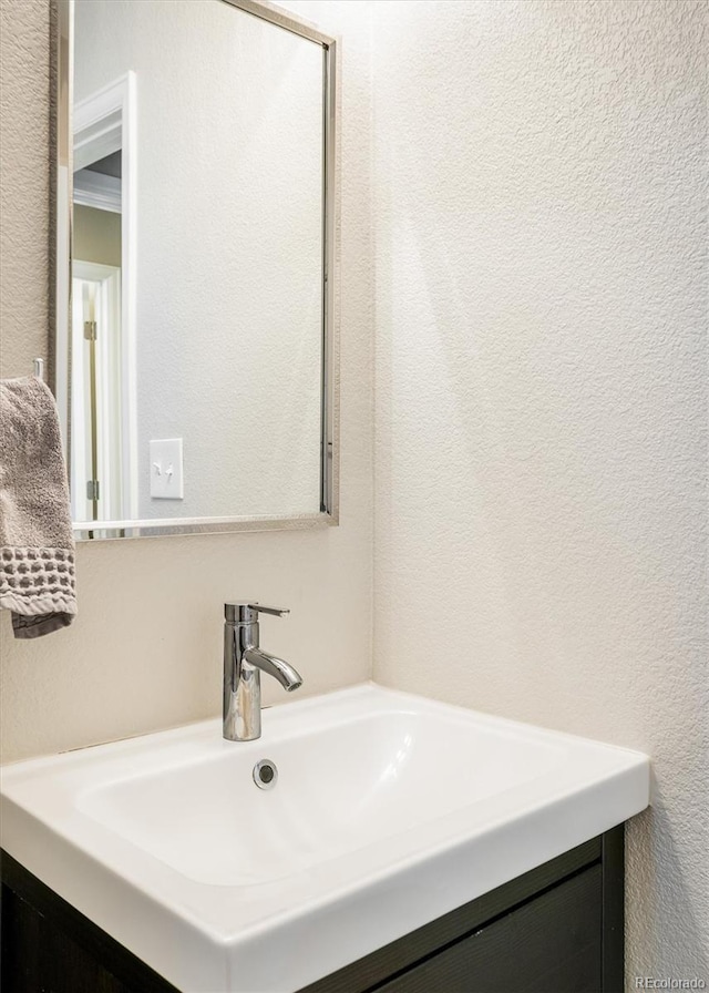 190 S Canosa Ct, Denver, CO 80219 - bathroom with a textured wall and vanity