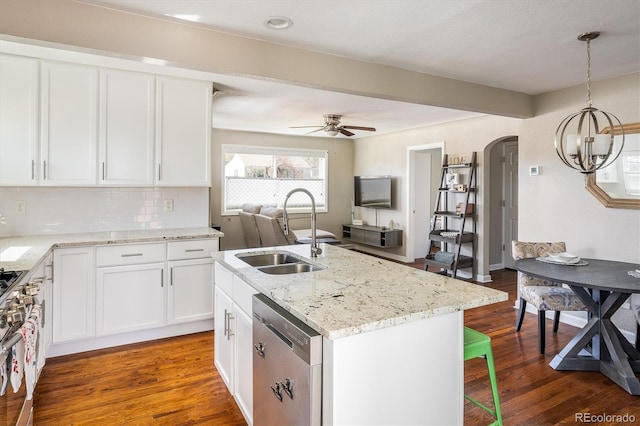 190 S Canosa Ct, Denver, CO 80219 - kitchen featuring arched walkways, white cabinetry, appliances with stainless steel finishes, a healthy amount of sunlight, and a sink
